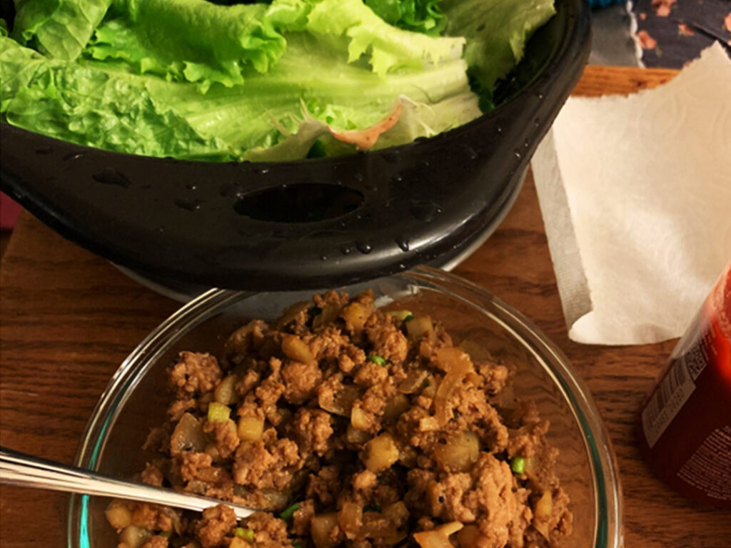 One bowl of lettuce for the wraps. Another of a chicken filling mixture.
